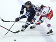 Winnipeg Jets centre Pierre-Luc Dubois stickhandles with New York Rangers centre Mika Zibanejad checking him in Winnipeg on Sunday, March 6, 2022.