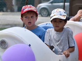 Xander (left) and Parker Ryan ride the midway train at the 163rd Comber Fair on Saturday, Aug. 6, 2022.