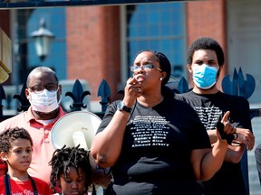 Protesters, including Eric Garner Jr., (R) gather at the State House as Monica Cannon-Grant(C), speaks during a Juneteenth protest and march in honor of Rayshard Brooks and other victims of Police Violence in Boston, Massachusetts on June 22, 2020. (Photo by Joseph Prezioso/AFP via Getty Images)