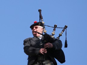 A man plays the bagpipes at a ceremony for the Devil's Brigade at City Hall Square, Saturday, Sept. 28, 2013.