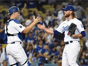 Los Angeles Dodgers catcher Will Smith (16) and relief pitcher Craig Kimbrel (46) celebrate after defeating the Minnesota Twins at Dodger Stadium in Los Angeles, Aug. 10, 2022.