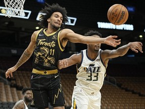 Jan 7, 2022; Toronto, Ontario, CAN; Toronto Raptors forward Justin Champagnie and Utah Jazz forward Elijah Hughes reach for a rebound during the second half at Scotiabank Arena.