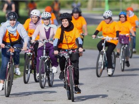 Local participants in 'Young Women in Motion: Breaking Barriers with Bikes' take a group ride along Windsor's riverfront, on Wednesday, Aug. 31, 2022.