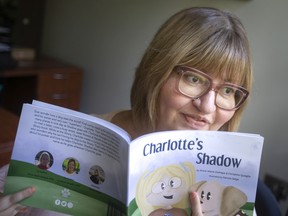 Children's author Christine Quaglia is pictured with her book, Charlottle's Shadow, she co-authored with Anne-Marie DePape, on Thursday, August 18, 2022.