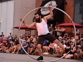 Busker Andy Giroux a.k.a. Limited Edition Andy performs with a Cyr Wheel at Busk On the Block in Windsor's Walkerville area on Aug. 6, 2022.