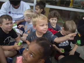 Kids at ABC Daycare are given hats and miniature toy trucks from staff at Windsor Disposal Services, on Wednesday, August 3, 2022.