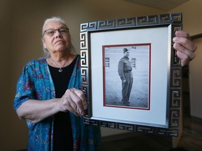 Theresa Sims, Windsor Indigenous storyteller, will be accompanying vets and is a special guest of the Dieppe Raid 80th anniversary that Windsor is hosting. Sims poses Aug. 12, 2022, with a photo of her father Robert James Sims who survived the Dieppe Raid on Aug. 19, 1942, but was seriously injured.