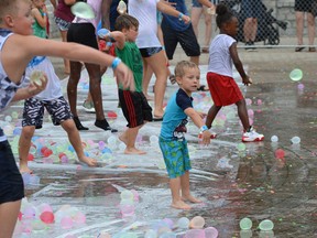 Four-year-old William Doucher, centre, looks for a target for his water balloon Saturday, Aug. 20, 2022, at the 6th annual Spotted in Windsor Water Balloon Fight, a fundraiser for Erie Shores Health Foundation.