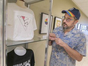 Walkerville high school teacher and historian, Walter Cassidy, curator for the exhibit Out of the Shadows; On to the Streets: 180 Years of 2SLGBTQIA+ Visibility in Windsor-Essex, discusses the display of t-shirts from the 1st and 3rd pride parade in Windsor, on Thursday, August 4, 2022.