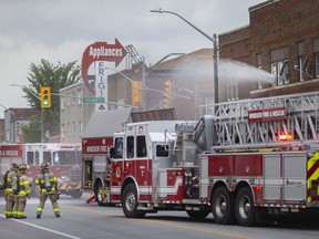 Windsor fire crews work to put out a fire in a second-floor residential unit in the 1300 block of Wyandotte Street East on Friday, Aug. 5, 2022.