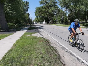 A cyclist travels on Riverside Drive east of Lesperance Road in Tecumseh on Aug. 10, 2022.