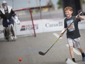 He shoots! He scores! Riley Morton is all smiles on Friday, Aug. 5, 2022, after beating the goalie during a shoot-around before the start of Play On! — a street hockey festival this weekend in downtown Windsor.