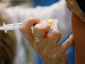 A pediatrician in Miami, Florida, administers a dose of HPV vaccine to a 13-year-old girl in this 2011 file photo.