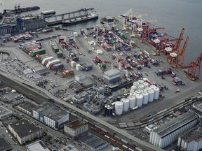 Cargo containers and ships at the Port of Metro Vancouver are seen in an aerial view in Vancouver on April 9, 2022. Ports and warehouses overflow even as cargo decreases, hitting shippers and consumers.