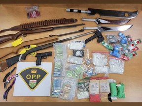 Firearms, knives, drugs, and drug paraphernalia seized by OPP in a raid on a residence on Sturgeon Meadows Avenue in Leamington on Aug. 8, 2022.