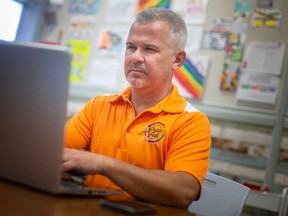 David Lenz, director of community development with Windsor-Essex Pride Fest, works at the Windsor Pride office on Aug. 5, 2022.