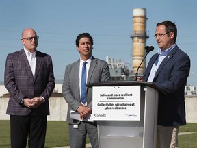 Windsor Mayor Drew Dilkens (left) and City of Windsor engineer Chris Nepszy look on as Windsor-Tecumseh MP Irek Kusmierczyk announces $33 million in federal support to build a new water retention basin at Windsor's Lou Romano Water Reclamation Plant. Photographed Aug. 31, 2022.