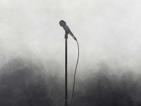 A microphone on a stage is shown in this stock image.