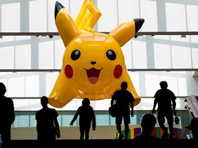 A giant inflatable Pikachu looms over people arriving at the 2019 Pokemon World Championships in Washington, D.C.