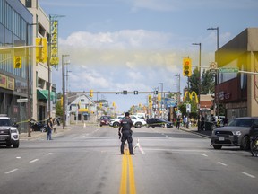 Windsor police investigate after a man was shot by police while wielding a machete at people at the intersection of Wyandotte Street and Ouellette Avenue, on Monday, August 15, 2022.