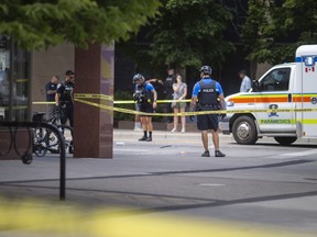 Windsor police investigate after a man was shot by police while wielding a machete at people at the intersection of Wyandotte Street and Ouellette Avenue, on Monday, August 15, 2022.