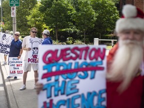 Protesters opposed to providing children with the COVID-19 vaccine hold a rally outside the Windsor-Essex County Health Unit, on Monday, August 15, 2022.