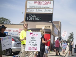 People opposed to the Covid-19 vaccine and vaccine mandates, protest outside an urgent care clinic on Howard Avenue, on Wednesday, August 3, 2022.