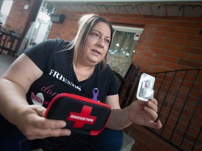 Windsor community activist Lisa Valente of House of Hope holds a naloxone kit at her home on Aug. 30, 2022. Valente has organized a downtown Windsor event to recognize international Overdose Awareness Day on Aug. 31.