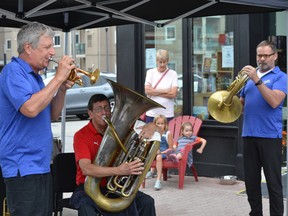 Windsor Symphony Orchestra's Ross Turner, from left, Brent Adams and Tim Lockwood perform Sunday, Aug. 14, 2022, outside the River Bookshop in Amherstburg, warming up for the final summer series concert at the Navy Yard Park.