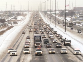 A group of OPP cruisers lead a long line of vehicles as traffic started moving on Hwy. 400.