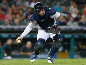 Catcher Tucker Barnhart of the Detroit Tigers fields a soft grounder hit by Mauricio Dubon of the Houston Astros for an out during the seventh inning at Comerica Park on September 13, 2022, in Detroit, Michigan.