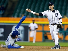 Second baseman Javier Baez of the Detroit Tigers turns the ball for a double play after getting the force out on Bobby Witt Jr. of the Kansas City Royals during the 10th inning at Comerica Park on September 27, 2022, in Detroit, Michigan. Vinnie Pasquantino hit into the double play.