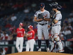 Garrett Hill and Eric Haase of the Detroit Tigers meet on the mound during the seventh inning against the Los Angeles Angels at Angel Stadium of Anaheim on September 05, 2022 in Anaheim, California.