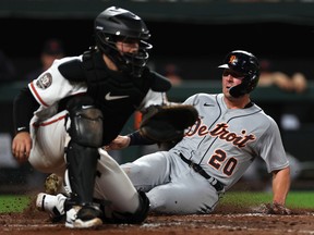 Spencer Torkelson of the Detroit Tigers scores a run in front of catcher Adley Rutschman of the Baltimore Orioles during the seventh inning at Oriole Park at Camden Yards on September 19, 2022 in Baltimore, Maryland.