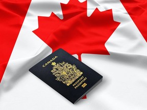 A Canadian passport is pictured on top of a Canadian flag in this photo illustration.
