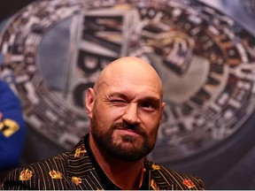 In this file photo taken on April 20, 2022 World Boxing Council (WBC) heavyweight title holder Britain's Tyson Fury winks during a pre-match press conference at Wembley Stadium in west London. -