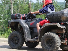 A youth rides an off-road vehicle in Fort McKay First Nation in Alberta in this 2019 file photo.