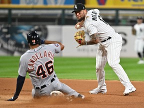 Chicago White Sox infielder Yoan Moncada throws to first base to complete a double play after forcing out Detroit Tigers infielder Jeimer Candelario in the eighth inning at Guaranteed Rate Field.