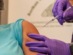 A woman receives a dose of bivalent vaccine against COVID-19 in New York City.