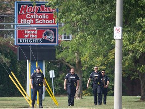 Windsor police officers are seen at the front of Holy Names Catholic High School after a bomb threat was made, on Friday, Sept. 16, 2022.