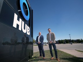 CRBE Windsor's Brook Handysides, left, and Brad Collins pose in front of a commercial property on Thursday, September 8, 2022, on Rhodes Drive in Windsor that sold recently.