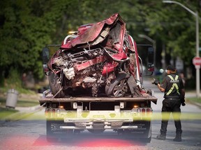A flatbed truck prepares to move the wreckage of a car involved in a single-vehicle collision in the 2500 block of Princess Ave. in Windsor. Photographed Sept. 15, 2022.