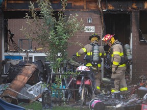 Firefighters in the aftermath of a blaze at a townhome in the 2900 block of Grandview Street in Windsor on Sept. 17, 2022.