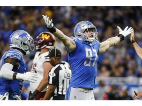Detroit Lions' rookie defensive end Aidan Hutchinson (97) celebrates a sack against  Washington Commanders quarterback Carson Wentz (11) during the first half at Ford Field. Mandatory Credit: Junfu Han-USA TODAY Sports