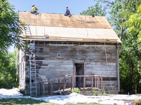 Workers from Double AA Metal Roofing are shown Thursday, Sept. 1, 2022, preparing a heritage home at the John Freeman Walls Historical Site in Lakeshore for a new roof.