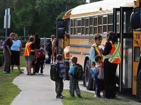 Young students prepare to board a bus at Glenwood Public School in Windsor.