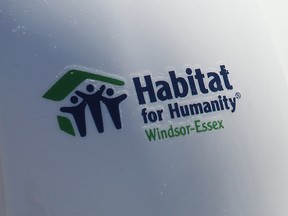 The Habitat for Humanity Windsor-Essex logo is shown on a hardhat in 2016.
