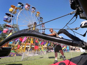 Gregor Wolff gets a midway ride ready for the 166th edition of the Harrow Fair. Photographed Sept. 1, 2022.