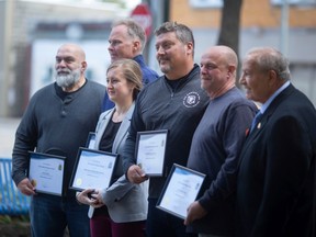 The team at McDonald & Co., pose for a photo with ward 5 Coun. Ed Sleiman, after being given a 2022 Built Heritage Award for the work they did at 1008 Drouillard Rd., where the City Cyclery is located, on Thursday, Sept. 22, 2022.