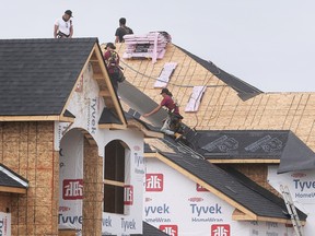 Construction workers are shown on Tuesday, Sept. 6, 2022, at a new home under construction at Lauzon Road and McHugh Street.